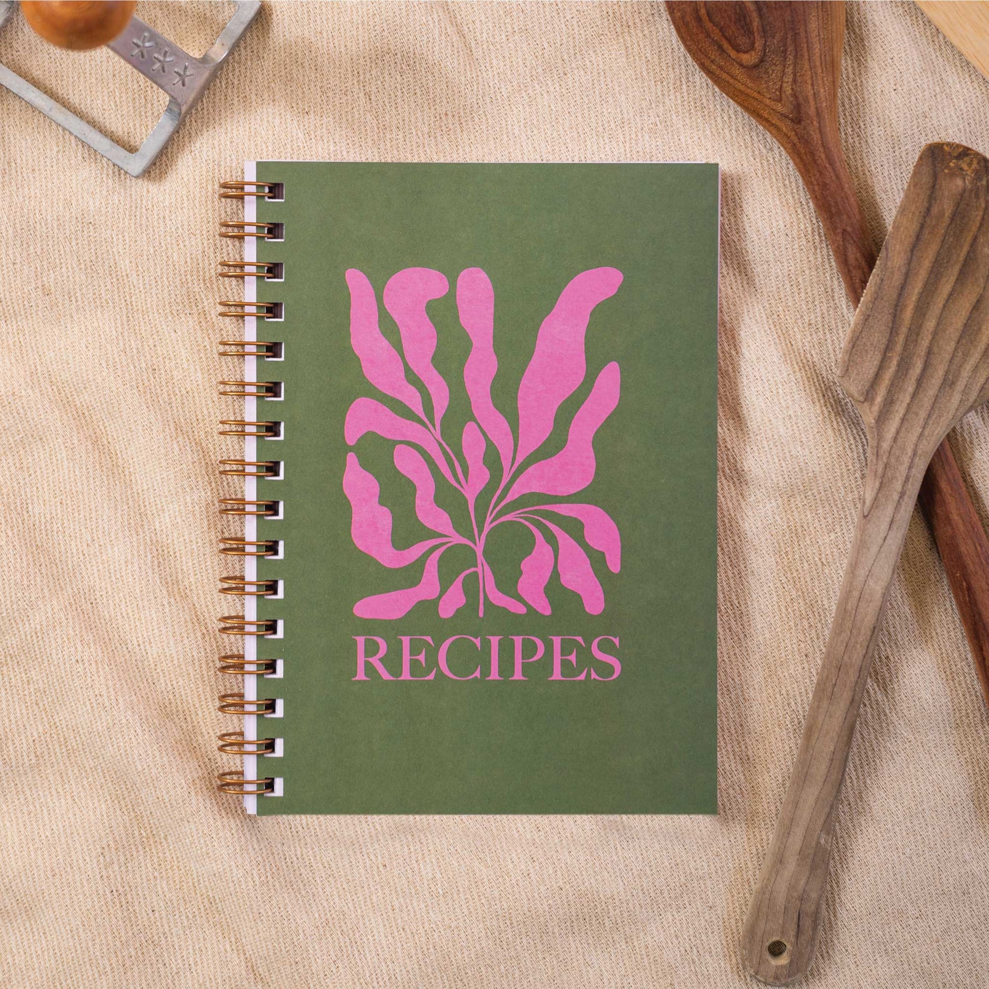 Recipe Book Journal A5. Made in the UK. This wire-o bound, blank recipe journal are made up of 128 pages which include handy cooking conversions, index pages, 52 double spread recipe pages, and note pages at the back. With space to add up to 52 recipes. It’s deliciously colourful throughout with bright, pink and green botanical cover. As it’s spiral bound, this recipe book lays perfectly flat.