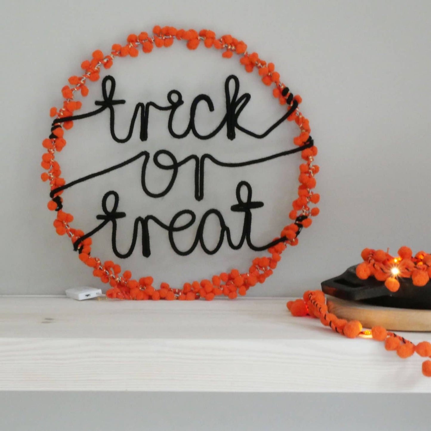 Lively orange pom poms design, these light-up Trick or Treat hoops are sure to set the mood for a memorable Halloween celebration. 