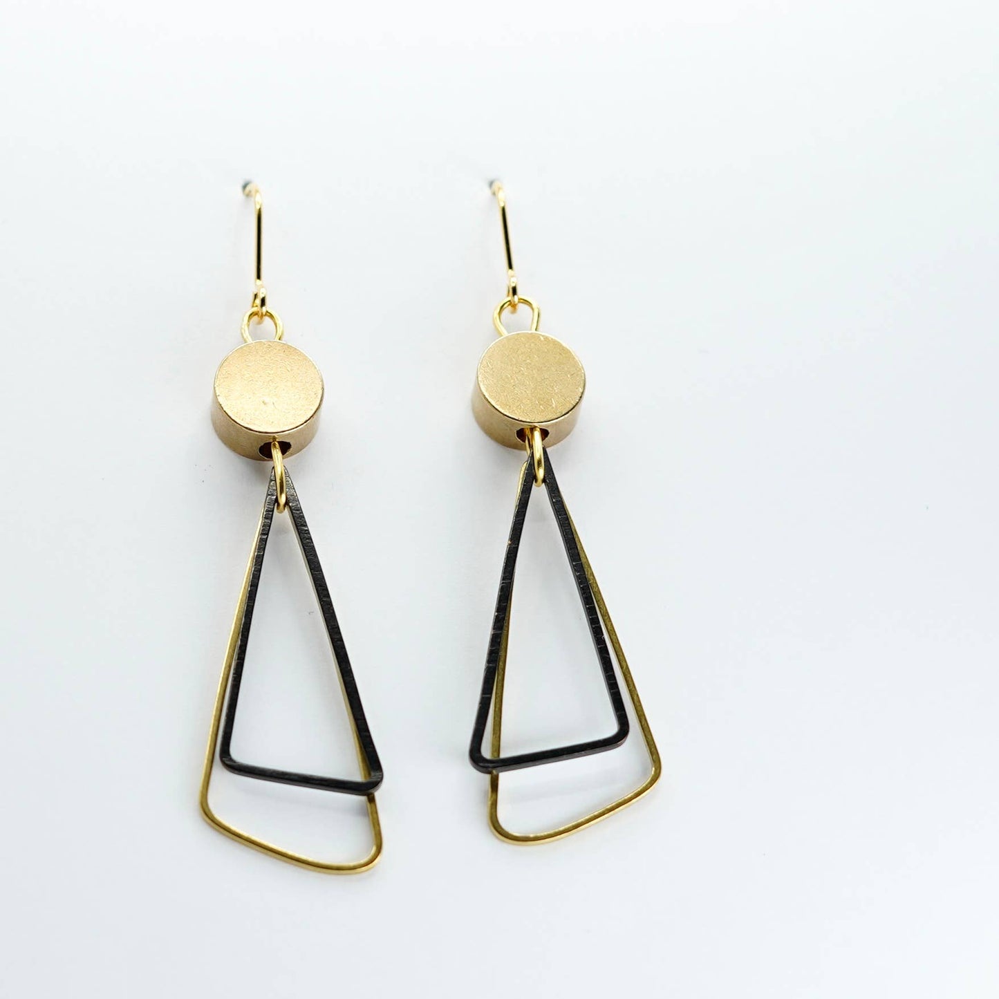 Black + Brass | Triangles Drop Earrings. A striking pair of earrings - two open triangles (one brass, one oxidised black brass) overlap under a brass disc bead.