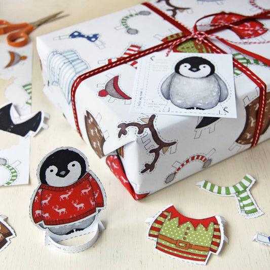 Dress Up A Penguin Christmas Wrapping Paper. Which can be used afterwards to cut out the penguins and dress them in Christmas jumpers and scarves.