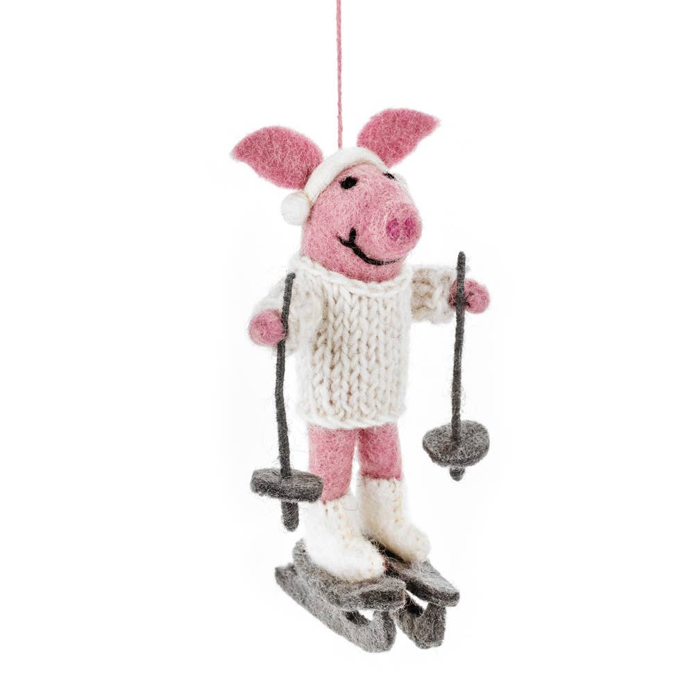 Alpine Swine Hanging Christmas Decoration. This Skiing Pig won’t have any trouble keeping warm on the slopes with her handknitted turtleneck, and it perfectly matches her wet felted ski boots and ear muffs that have been handstitched to her needle felted body