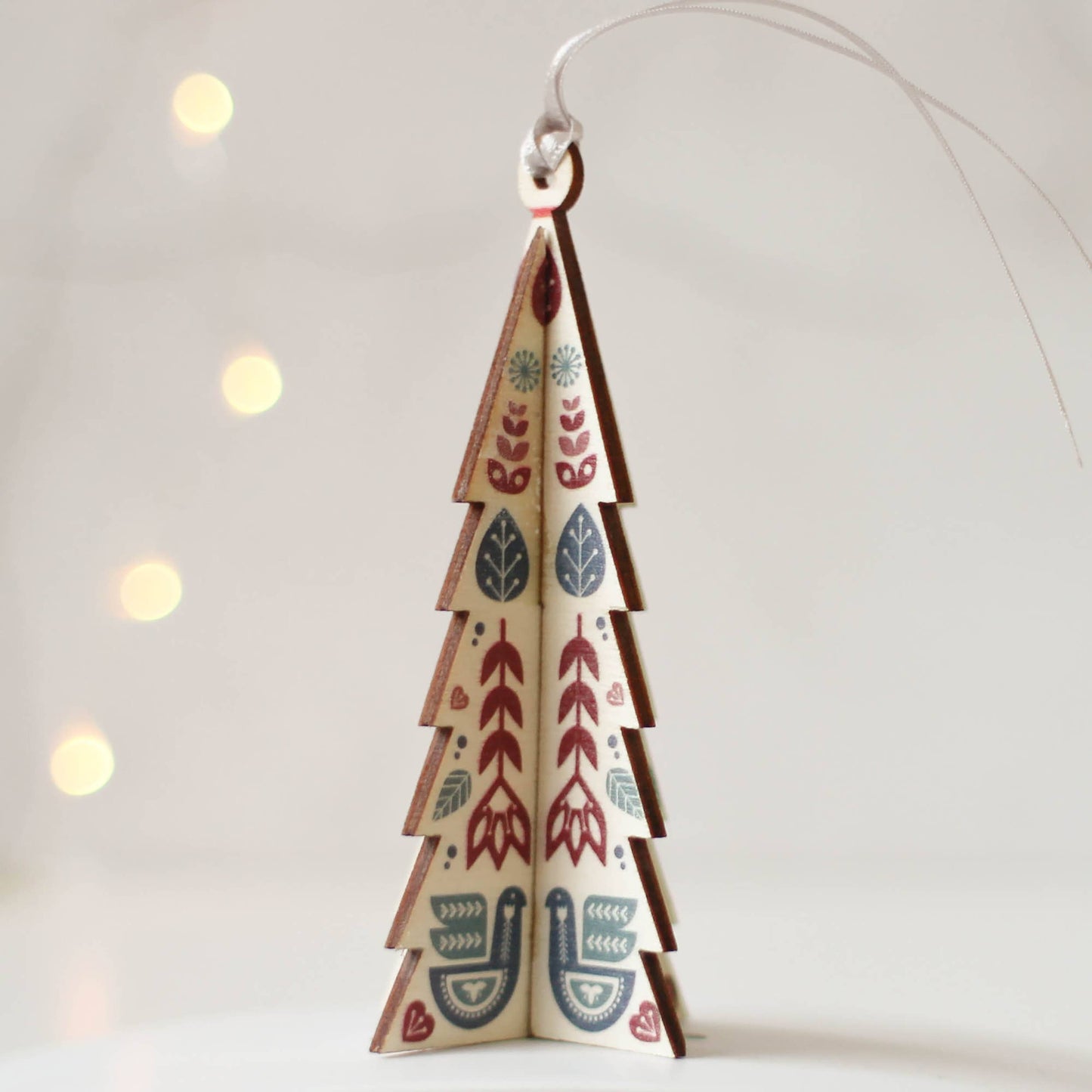 Decorate your home with cheer this season with; mini Christmas trees decoration for the tree, finished with a pleasing Scandi folk design, designed to hang on your tree.